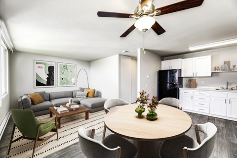 a living room with a dining room table and a kitchen
